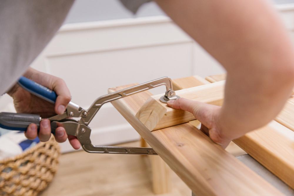 Clamping a seat support board to one of the boards that will become the bench top.