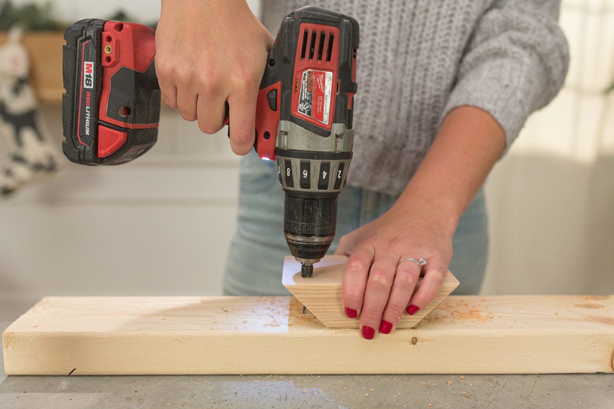 Drilling pilot hole into beveled piece of fir. 