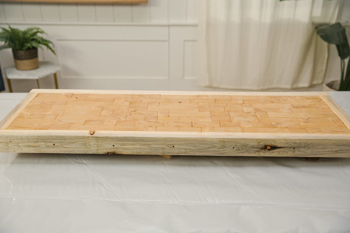 Drilling pocket hole in center brace with Kreg jig and power drill. 