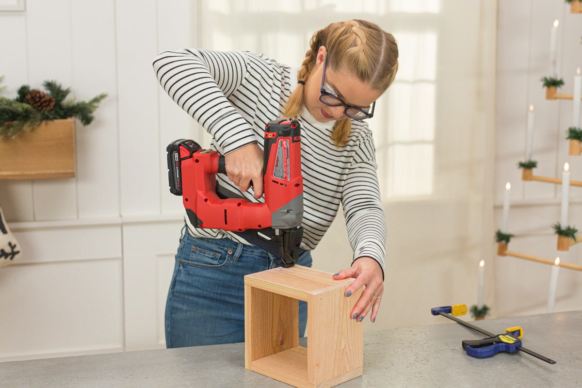 Attaching clamped square pieces at a right angle with a nail gun.