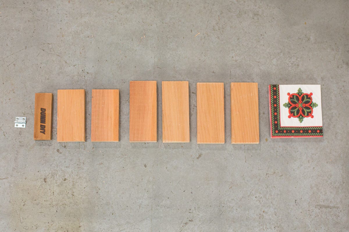 Paper napkins, cut wood rectangles and a small hinge laid out.