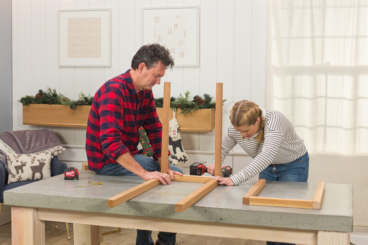 Driving screw with power drill to build second side onto DIY wooden outdoor beverage cart box frame assembly.