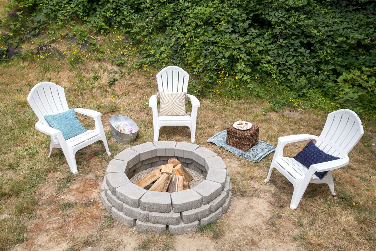 Patio chairs positioned around a DIY outdoor fire pit.