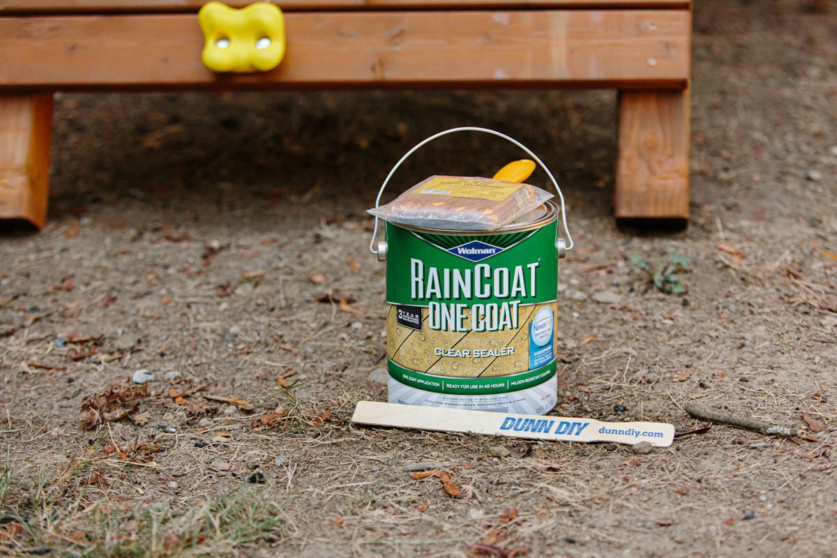 Can of Wolman RainCoat One Coat Clear Sealer and stir stick.