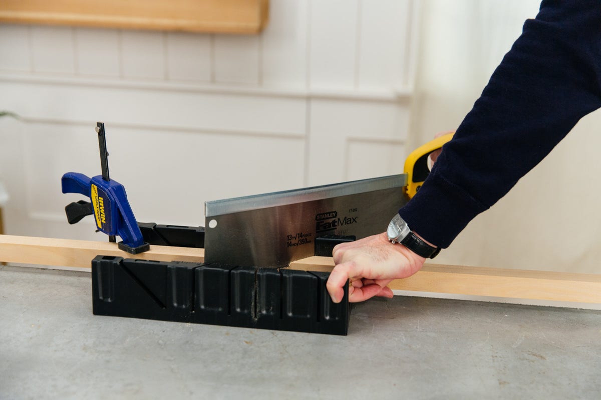 Cutting clamped square moulding with miter box and hand saw