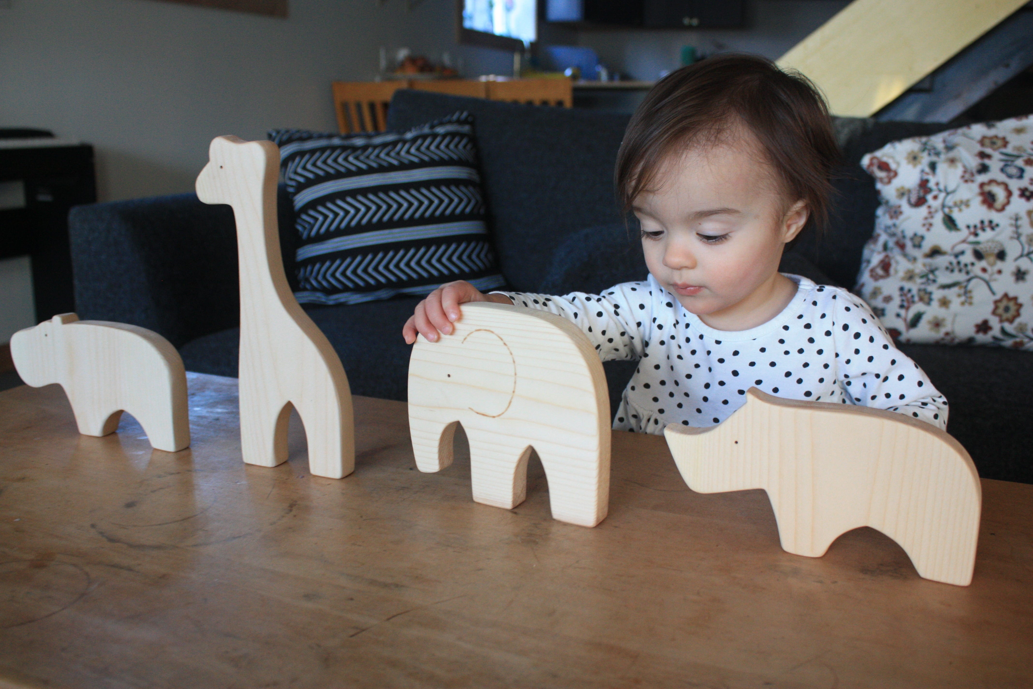 Child playing with DIY wood animal blocks. 