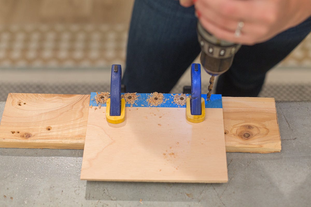 Drilling holes in taped edge of clamped DIY school year journal cover.