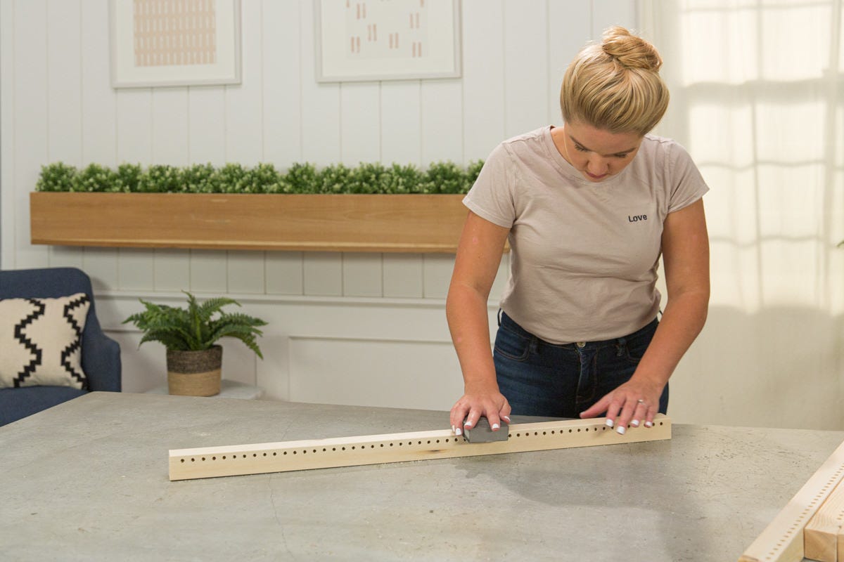 Sanding loom boards with sanding sponge.