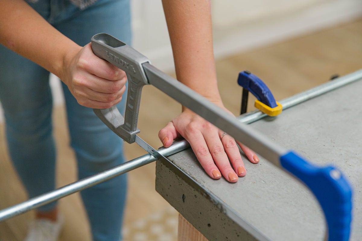 Cutting clamped axle with hacksaw.