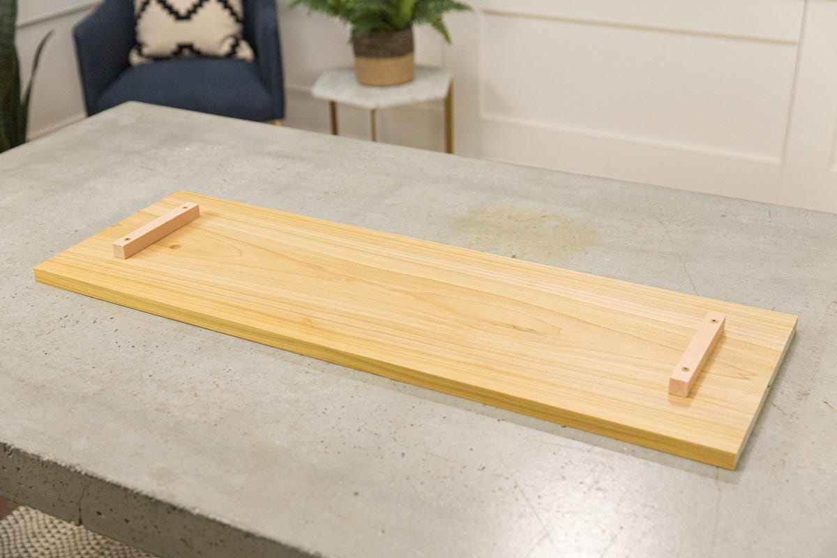 Poplar shelf with two pieces of scrap wood attached near either short side. 